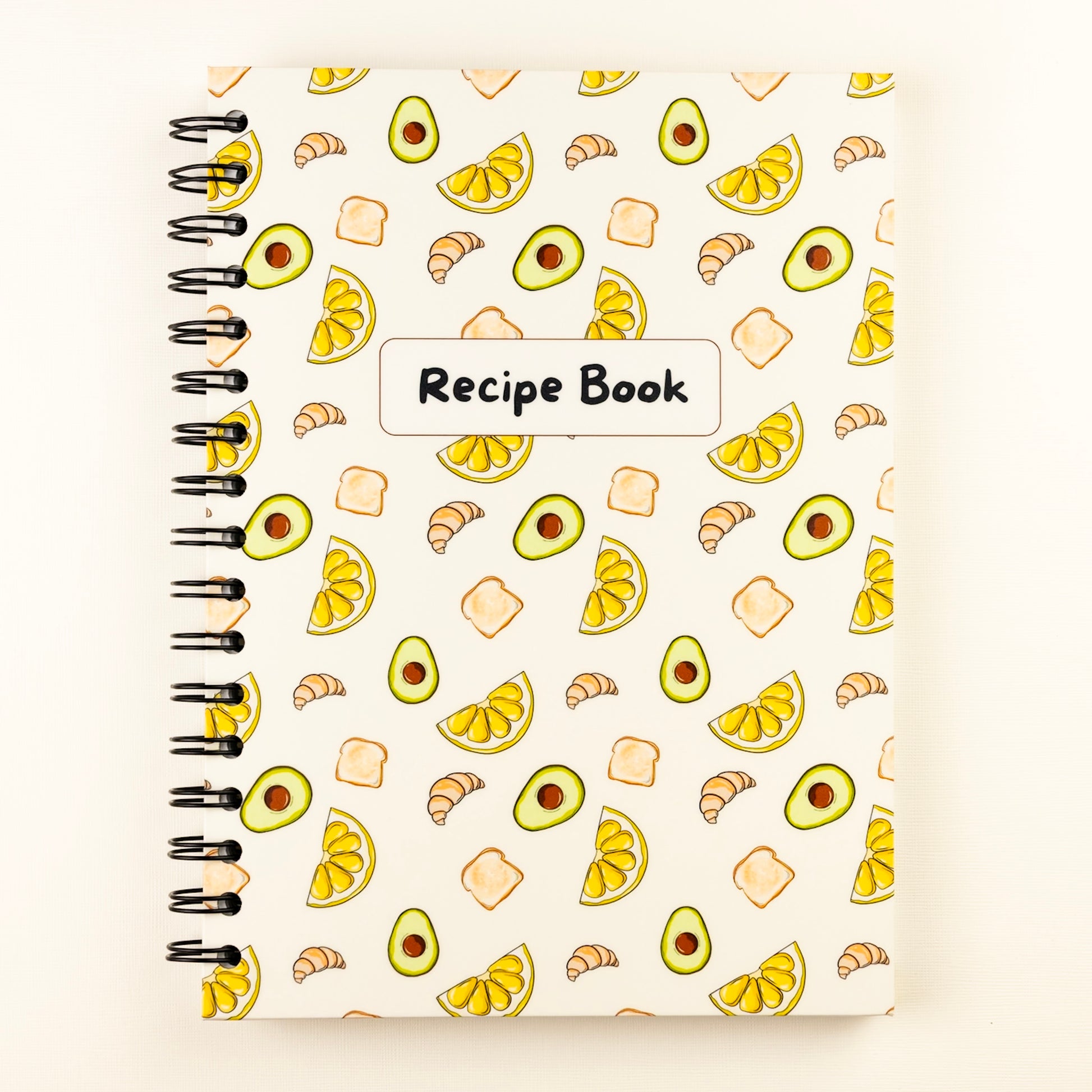 Lemon and avocado themed biege spiral-bound recipe book